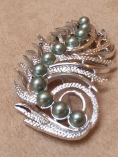 Sarah Coventry jewelry collection.Floral silver tone pearl large brooch.Great quality and excellent condition!Ready to ship! Unique Silver Brooches For Anniversary, Unique Silver Brooches For Evening, Silver Costume Jewelry Brooch For Formal Occasions, Silver Costume Jewelry Brooches For Formal Occasions, Unique Silver Brooch For Anniversary, Unique Silver Anniversary Brooch, Ornate Sterling Silver Brooches For Gifts, Silver Filigree Brooches For Collectors, Sara Coventry Jewelry Vintage