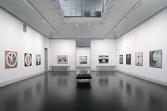 an empty room with paintings on the walls