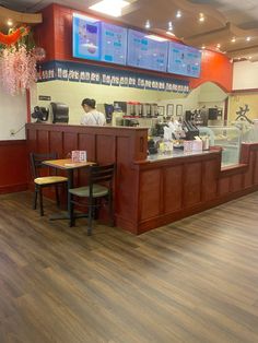 the inside of a fast food restaurant with wood flooring