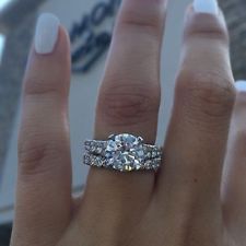 a woman's hand with a diamond ring on it