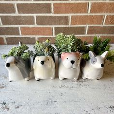 four ceramic dogs with plants in their mouths