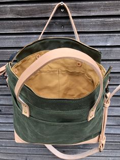 Tote bag with luggage handle attachment in American heavy weight waxed canvas. The color is olive green for the body and natural vegetable tanned leather for the bottom. I made it into an everyday bag perfect for the office, with leather handles, shoulder strap, and 3 outside pockets Closing with a zipper on top. And on the backside a luggage handle attachment Including a leather shoulder strap, adjustable and detachable. All made in natural vegetable tanned leather Fully lined with a cotton can Green Waxed Finish Tote Shoulder Bag, Green Waxed Canvas Everyday Bag, Everyday Green Waxed Canvas Bag, Green Canvas Satchel With Leather Handles, Green Duck Canvas Travel Bag, Green Waxed Canvas Tote Shoulder Bag, Green Waxed Canvas Bag For Daily Use, Green Canvas Shoulder Bag With Waxed Finish, Green Waxed Canvas Bag For Everyday Use