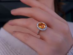 a woman's hand with a yellow and white diamond ring