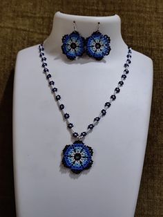 a necklace and earring set with blue beads