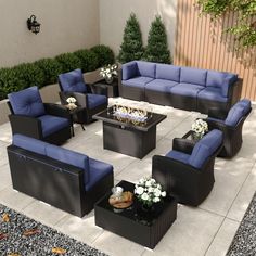 an outdoor seating area with blue and black furniture