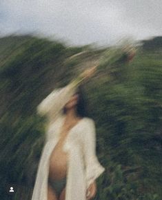 blurry photograph of a woman in white dress