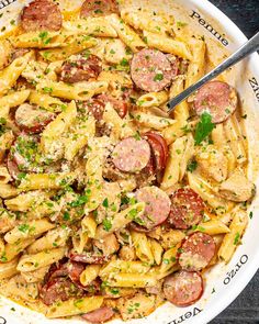 a white bowl filled with pasta and sausage