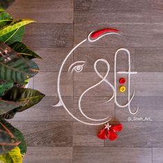 the logo for an art gallery is displayed on a wooden floor with leaves and flowers