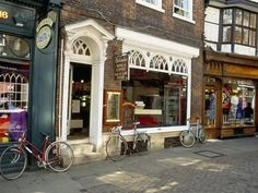 two bicycles parked outside the front of a store