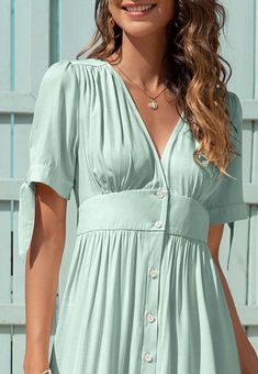 The EMES SHOP dress is detailed with fun tie sleeves. Features a v neck line. button down design. short sleeves. flowy dress. and mid-calf length. Pair it with sunnies and espadrilles for a magnificent summer look.MATERIALS: 91-99 % PolyesterMEASUREMENTS: Product length is 50"-51.9" 4-6-Small | Waist: 25-26.5 in | Chest: 33-34.5 in | Hips: 35-36.5 in 6-8-Medium | Waist: 26.5-28 in | Chest: 34.5-36 in | Hips: 36.5-38 in 8-10-Large | Waist: 28-29.5 in | Chest: 36-37.5 in | Hips: 38-39.5 in 10-12-X V-neck Midi Dress With Button Closure For Vacation, Summer Mid-length Dress With Button Closure, V-neck Midi Dress For Beach Season Daywear, Casual Fitted Dress With Tie Sleeves, Green Summer Midi Dress With Button Closure, Trendy Short Sleeve Midi Dress For Vacation, Casual Summer Midi Dress With Button Closure, Summer Button Closure Midi Dress For Day Out, Casual V-neck Daytime Dress