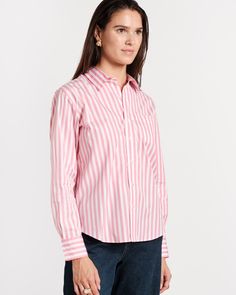 Our Perfect Button Down is that classic top that never leaves your wardrobe. Updated in a new pink and white stripe poplin, this basic goes with just about everything in your closet. Women’s button up with bracelet-length sleeves and classic shirt collar Updated in bold navy & white stripes Made with cool & crisp 100% cotton poplin Detailed with embroidered heart on collar & FV’s signature XO on cuff Made in Turkey Classic Pink Top With Striped Collar, Closet Women, Pink Button-up Top With Button Cuffs, Pink Relaxed Fit Button-up Shirt, Pink Button-up Shirt With Placket, Pink Vertical Stripes Button-up Top, Frances Valentine, Pink And White Stripes, Essential Dress