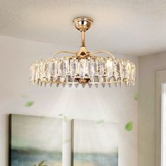 a chandelier hanging from the ceiling in a room with paintings on the wall