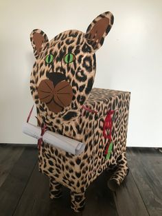 a cardboard animal sitting on top of a wooden floor