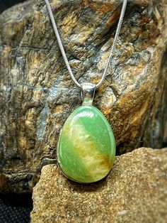 This beautiful, self collected green Aventurine from Western Wyoming has been cut and polished to a teardrop shape in our lapidary shop. It displays a beautiful shimmering 'apple' green with a vein of white quartz across the stone.  The stone was set on an engraved silver plated brass setting. Then a 1mm silver plated brass snake chain was added.  Snag this beautiful piece while it's available! Green Teardrop Gemstone Drop Necklace, Green Pear-shaped Drop Necklace Gift, Green Pear-shaped Drop Necklace For Gift, Green Teardrop Spiritual Necklace, Western Wyoming, Lake Superior Agates, Silver Snake Chain, Pretty Green, Silver Engraving