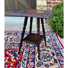 an old wooden table sitting on top of a rug