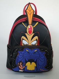 This is a Loungefly Disney Aladdin Jafar Villains Scene mini backpack.  Beautiful and durable cross-hatch black faux leather with the Jafar and the Cave of Wonders scene and black hardware.  Includes Iago the scarlet macow enamel zipper pull.  The bag is lined in black with Jafar and cobra print. Dimensions: 10.5"H x 9”W x 4.5”D This item is new...not pre-owned.  Impeccable condition.  The backpack was only removed from its original packaging for photos.  The item has been carefully stored in a Black Backpack For Theme Park, Black Disney-style Bag For Theme Park, Black Disney Backpack For Travel, Black Disney Bag For Theme Park, Black Disney Style Bag For Theme Park, Black Backpack For Theme Parks, Themed Black Backpack For Theme Parks, Black Disney Backpack For Disney Fan Events, Black Backpack With Zipper For Disney Fan Events