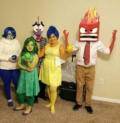 four people in costumes standing next to each other