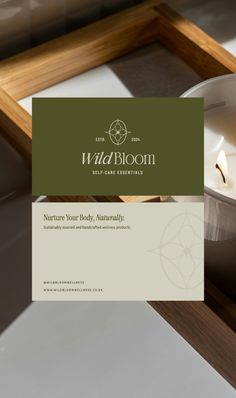 the logo and business card for wildboom candle essentials, which is on display