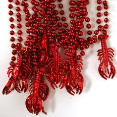 red beaded necklaces are arranged on a white surface