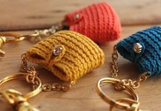 three crocheted purses sitting on top of a wooden table next to each other