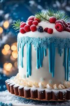 a frosted cake decorated with berries and blue icing on top of a table