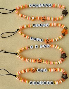 four halloween beaded bracelets with pumpkin faces and words on them, all decorated in different colors