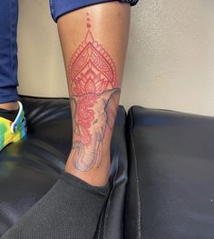 an elephant tattoo on the leg of a woman