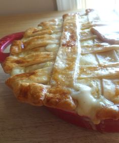 a close up of a pie on a wooden table with a window in the background