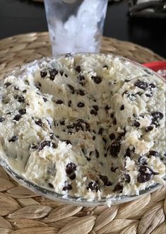 a cake sitting on top of a table covered in frosting and chocolate chip toppings