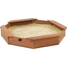 a wooden bird feeder filled with sand and grass on top of a white background in the shape of a hexagonal box