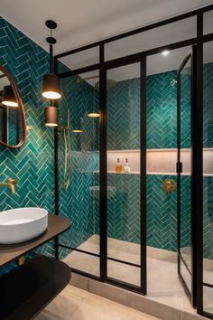 the instagram page shows an image of a bathroom with green tiles and gold fixtures