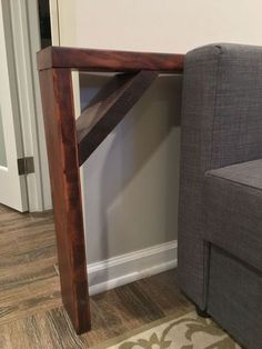 a gray chair sitting next to a wooden table