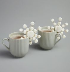 two mugs filled with hot chocolate and marshmallows