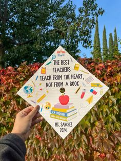 a person holding up a graduation cap with the words teachers teach from the heart, not from a book