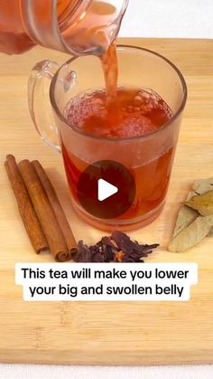 a person pouring tea into a glass cup