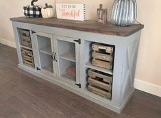 a wooden cabinet with crates and pumpkins on top