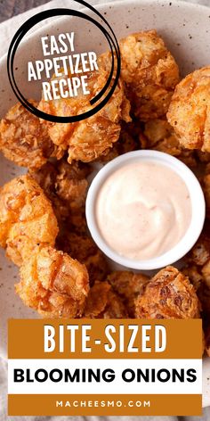 a white plate topped with tater tots covered in ranch dressing and dipping sauce