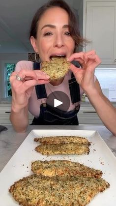 a woman is eating some food in the kitchen