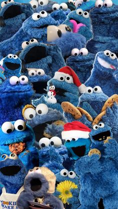 the sesame street characters are all dressed up in blue costumes and santa hats, with snowflakes on their heads