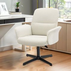 a white office chair sitting on top of a hard wood floor