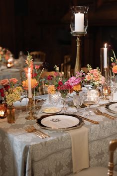 the table is set with flowers and candles for an elegant dinner party or special event