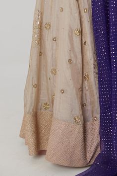 Gold banarasi silk tissue lehenga featuring bahar embroidery with sequin, aari and zardozi highlights. Paired with a purple half sleeves chevron fleur woven banarasi silk brocade blouse and blue-purple ombre mukaish embroidered organza dupatta., Fit: Relaxed Tissue Lehenga, Brocade Blouse, Aari Blouse, Brocade Blouses, Embroidered Organza, Purple Blouse, Organza Dupatta, Purple Ombre, Silk Brocade