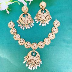 Featured is an all pearl necklace with matching pair of chandbali earrings in gold plated silver. The necklace set weights approximately 70gms Deccan Jewellery, 22k Gold Jewelry Necklaces, Jadau Jewellery, 22k Gold Jewelry, Chandbali Earrings, Pearl Necklace Set, Gold Jewelry Necklace, Emerald Necklace, Earrings In Gold