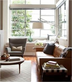 a living room filled with furniture and a large window