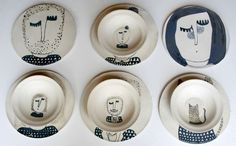 four plates with different designs on them sitting next to each other in front of a white wall