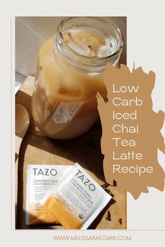 a glass jar filled with liquid next to a packet of tazo on top of a cutting board