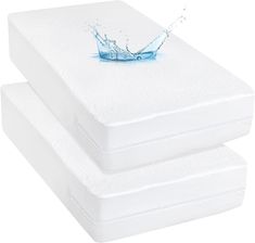 two white mattresses with water splashing on them