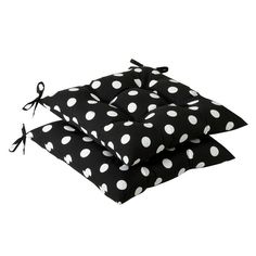 three black and white polka dot cushions with ties on them, one is tied to the pillow