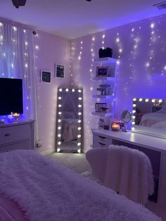 a bedroom with lights on the walls and white furniture