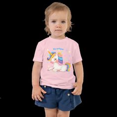 Cute children's shirt made of cotton. This sweet baby shirt features an enchanting unicorn print. Comfortable and also a gift for any little girl or boy. Let your kids run around in this short-sleeved 100% cotton jersey T-shirt with a unique print. The T-shirt is soft, durable and a staple in your child's wardrobe. * 100% combed ring-spun cotton * Fabric weight: 142 g/m² * Pre-shrunk material * Side seam * Relaxed fit for added comfort * Raw product sourced from Honduras or the USA Fun Unicorn Print T-shirt For Summer, Playful Cotton T-shirt With Unicorn Print, Cute Summer Cotton T-shirt, Summer Unicorn Print Crew Neck Top, Cute Unicorn Print Birthday T-shirt, Summer Crew Neck Top With Unicorn Print, Summer Unicorn Print Crew Neck T-shirt, White Unicorn Print T-shirt For Summer, Playful Cotton T-shirt With Cute Design